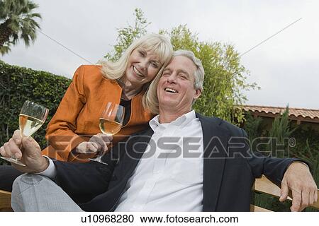 Couple drinking wine in garden, portrait View Large Photo Image Stock Image - Couple drinking wine in garden, portrait. Fotosearch