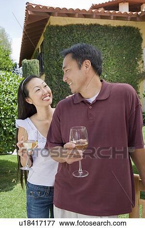 Couple drinking wine in garden View Large Photo Image Stock Photo - Couple drinking wine in garden. Fotosearch