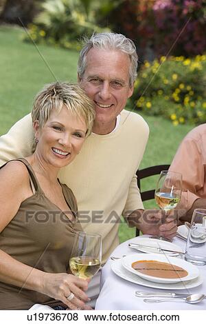 Couple drinking wine outdoors, portrait View Large Photo Image Stock Photo - Couple drinking wine outdoors, portrait. Fotosearch