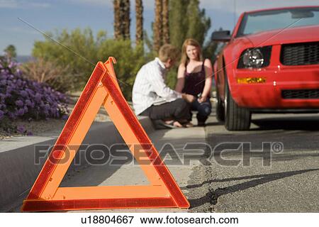 Stock Photo - Couple Having Car Trouble. Fotosearch