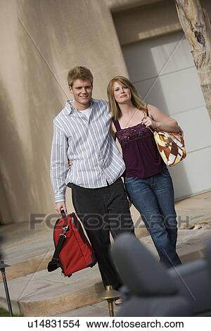 Picture - Couple Holding Luggage. Fotosearch