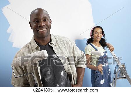 Couple holding paint rollers, portrait View Large Photo Image Stock Image - Couple holding paint rollers, portrait. Fotosearch
