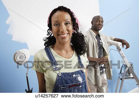 Couple holding paint rollers, portrait View Large Photo Image Stock Photo - Couple holding paint rollers, portrait. Fotosearch
