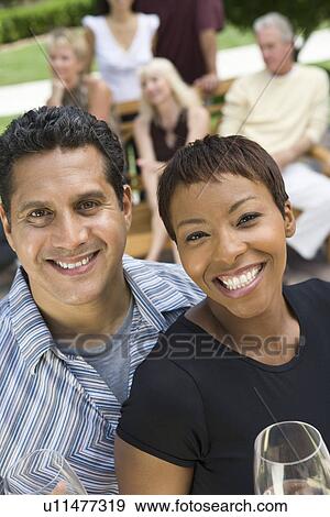 Couple holding wine outdoors, portrait View Large Photo Image Stock Photo - Couple holding wine outdoors, portrait. Fotosearch