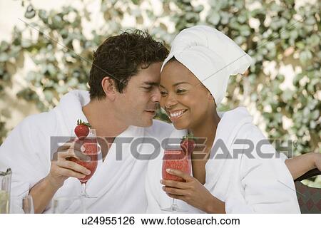 Couple in bathrobes, drinking at health spa View Large Photo Image Stock Photograph - Couple in bathrobes, drinking at health spa. Fotosearch