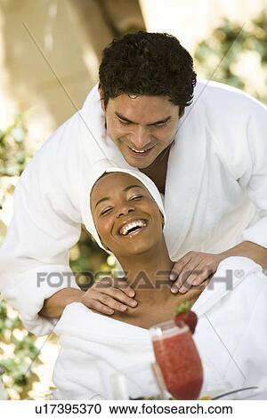 Stock Image - Couple in bathrobes, relaxing at health spa. Fotosearch