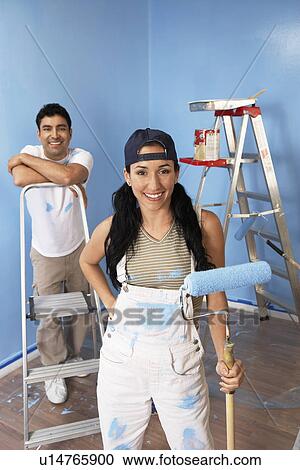 Couple in freshly painted room, portrait, elevated view View Large Photo Image Stock Image - Couple in freshly painted room, portrait, elevated view. Fotosearch