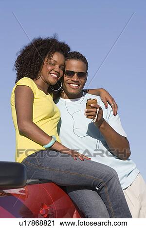 Stock Image - Couple Listening to MP3 Player. Fotosearch