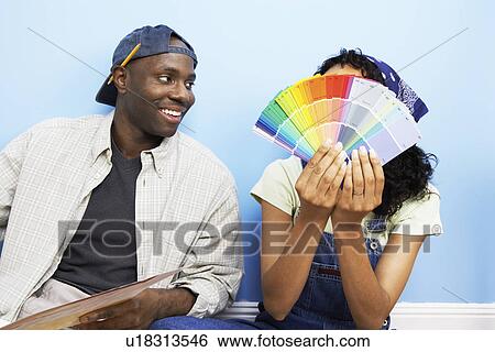 Couple looking at paint samples View Large Photo Image Stock Photograph - Couple looking at paint samples. Fotosearch