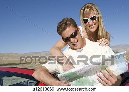 Stock Photo - Couple Looking at Road Map. Fotosearch