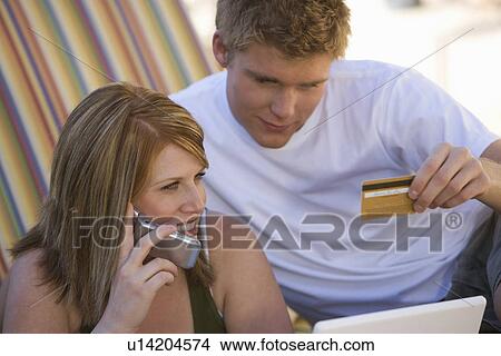 Picture - Couple Making Credit Card Purchase. Fotosearch
