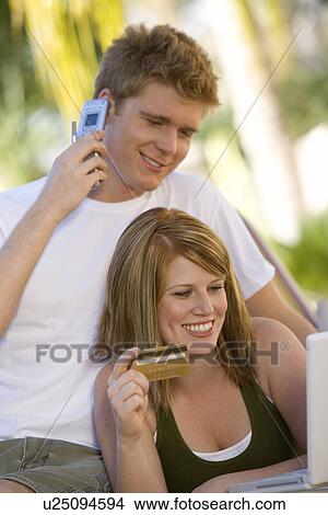 Picture - Couple Making Credit Card Purchase. Fotosearch