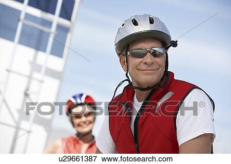 Stock Photo - Couple on bicycle ride, portrait. Fotosearch