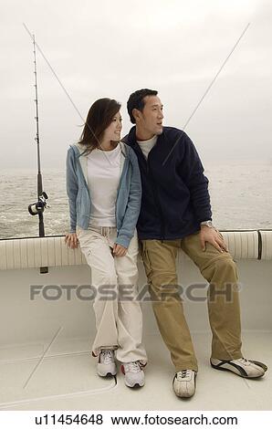 Stock Photo - Couple on fishing boat. Fotosearch