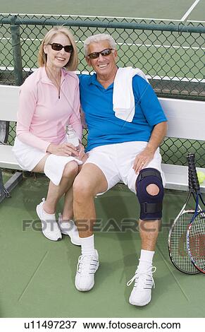 Couple on tennis court View Large Photo Image Stock Photo - Couple on tennis court. Fotosearch