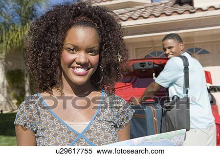 Stock Photography - Couple Packing Car. Fotosearch