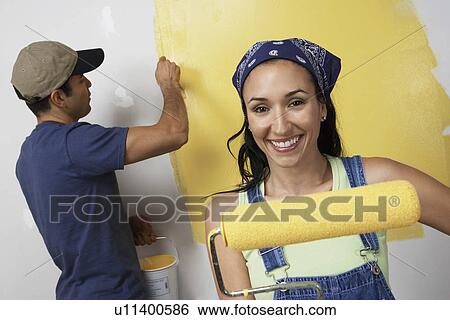 Couple painting interior wall yellow View Large Photo Image Stock Photograph - Couple painting interior wall yellow. Fotosearch