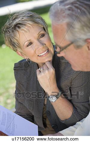 Couple smiling outdoors View Large Photo Image Stock Image - Couple smiling outdoors. Fotosearch