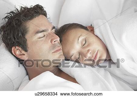 Picture - Couple snoozing at spa, head and shoulders. Fotosearch