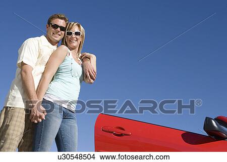 Couple Standing by Car View Large Photo Image Picture - Couple Standing by Car. Fotosearch