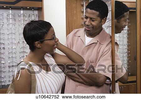 Couple trying on eyeglasses in store View Large Photo Image Stock Image - Couple trying on eyeglasses in store. Fotosearch