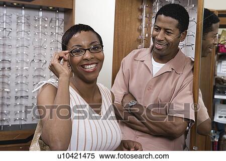 Couple trying on eyeglasses in store View Large Photo Image Stock Photography - Couple trying on eyeglasses in store. Fotosearch