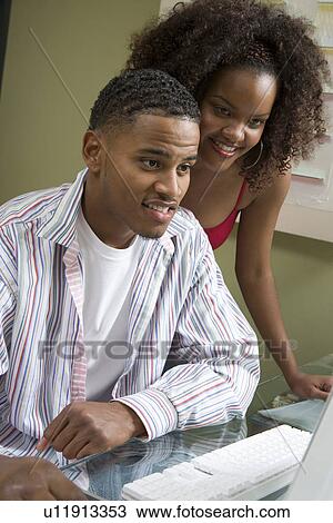 Stock Image - Couple Using Computer. Fotosearch