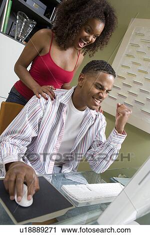 Stock Image - Couple Using Computer. Fotosearch