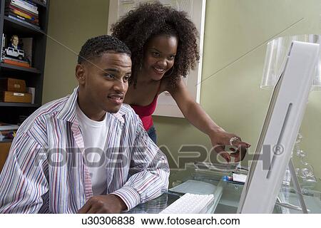 Stock Photo - Couple Using Computer. Fotosearch