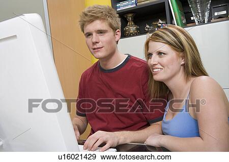 Stock Photo - Couple Using Desktop Computer. Fotosearch