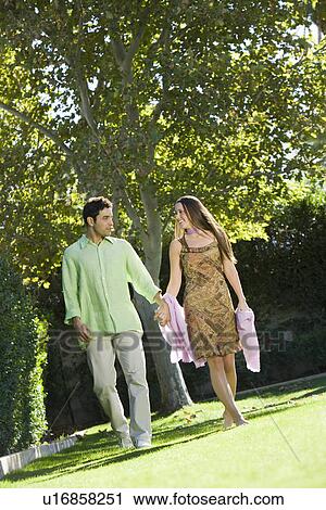 Couple walking in park View Large Photo Image Stock Image - Couple walking in park. Fotosearch