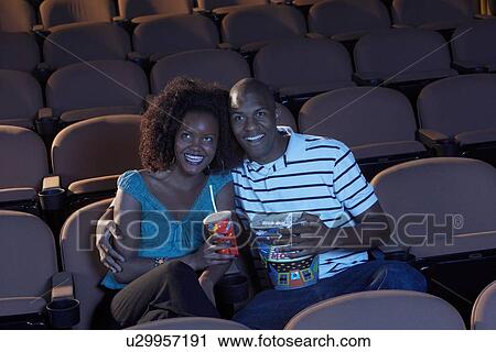 Stock Image - Couple Watching Movie. Fotosearch