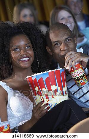 Stock Photo - Couple Watching Movie. Fotosearch