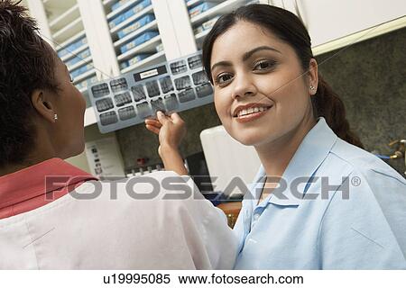 Stock Photography - Dentist and hygienist in laboratory, (portrait). Fotosearch