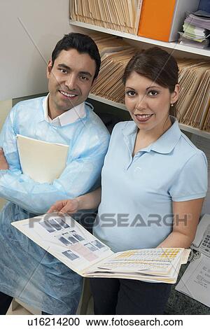 Stock Image - Dentist and hygienist in office, (portrait). Fotosearch