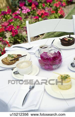 Desserts on outdoor table View Large Photo Image Stock Photograph - Desserts on outdoor table. Fotosearch