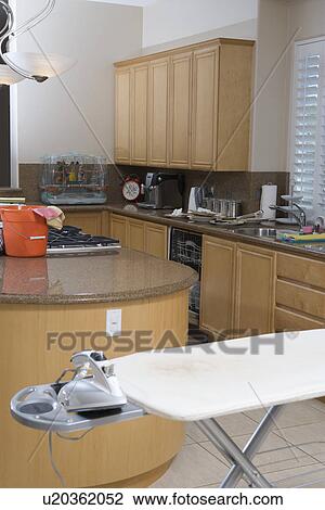 Domestic kitchen with ironing board and an iron View Large Photo Image Stock Image - Domestic kitchen with ironing board and an iron. Fotosearch