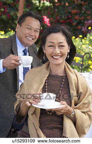 Elegant mature couple, holding cups of tea outdoors, View Large Photo Image Stock Photo - Elegant mature couple, holding cups of tea outdoors,. Fotosearch