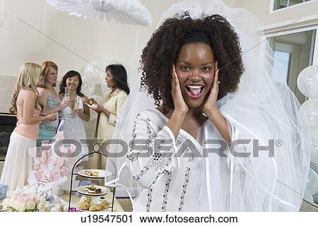 Excited bride wearing veil at bridal shower View Large Photo Image Stock Image - Excited bride wearing veil at bridal shower. Fotosearch