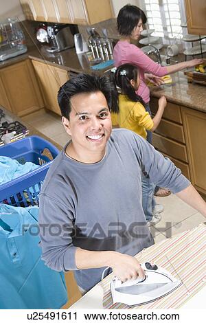 Stock Image - Family doing housework. Fotosearch