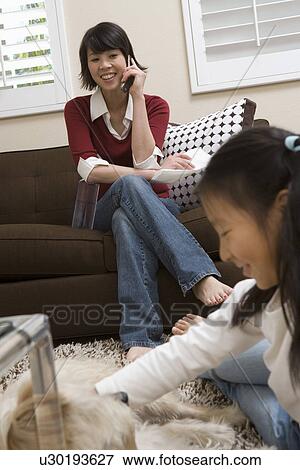 Stock Photo - Family including girl (10-12) at home. Fotosearch