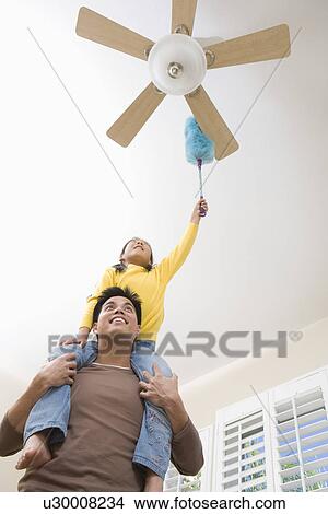 Picture - Family including girl (10-12) cleaning house. Fotosearch