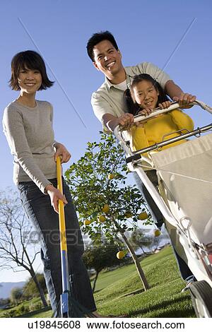 Family including girl (10-12) with garden equipment View Large Photo Image Stock Photo - Family including girl (10-12) with garden equipment. Fotosearch