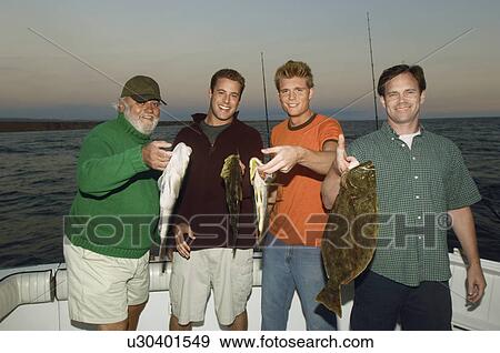 Stock Photo - Family of fishermen displaying fish, (portrait). Fotosearch