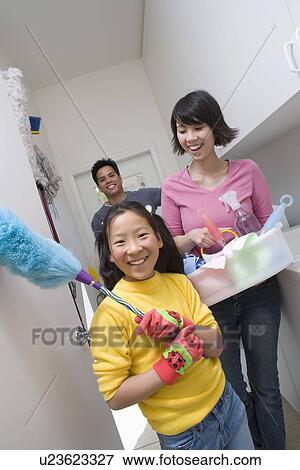 Stock Photo - Family with girl (10-12) doing housework. Fotosearch