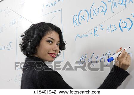 Female student writing maths equations on whiteboard View Large Photo Image Stock Image - Female student writing maths equations on whiteboard. Fotosearch