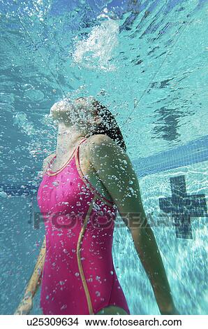 Female swimmer coming up for air, underwater View Large Photo Image Picture - Female swimmer coming up for air, underwater. Fotosearch