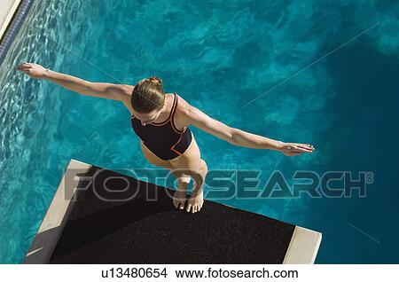 Female swimmer standing on diving board View Large Photo Image Picture - Female swimmer standing on diving board. Fotosearch