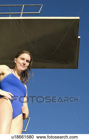 Female swimmer standing on diving board View Large Photo Image Stock Image - Female swimmer standing on diving board. Fotosearch