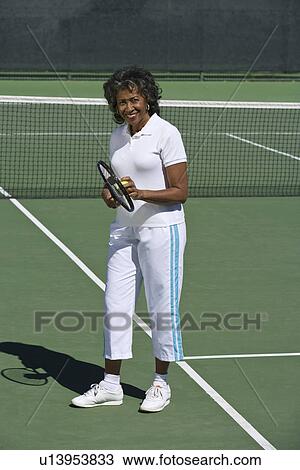 Female tennis player on court, portrait View Large Photo Image Stock Image - Female tennis player on court, portrait. Fotosearch